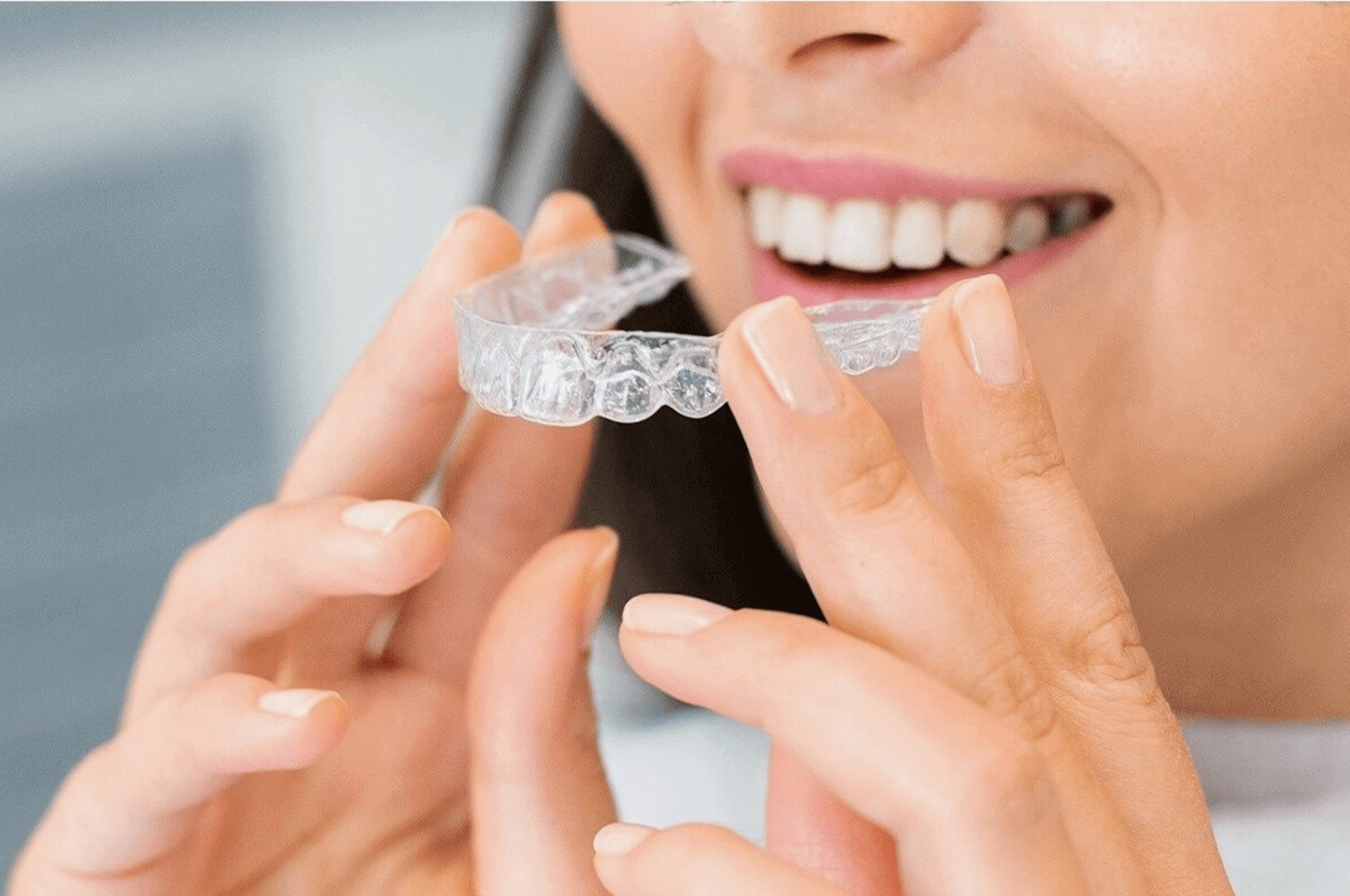 Woman holding clear braces in Arnold Dental in Nottingham