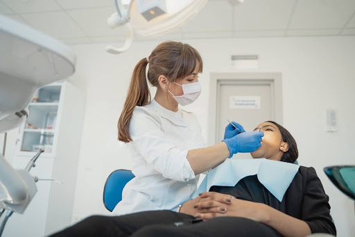 A dentist performing a minimally invasive dental procedure on a relaxed patient.