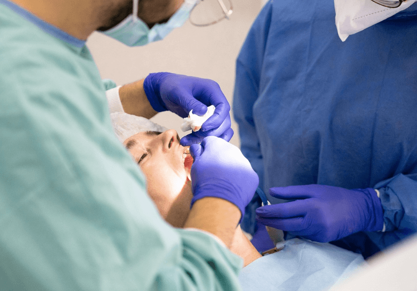 A person undergoing a crown fitting after dental implant surgery.