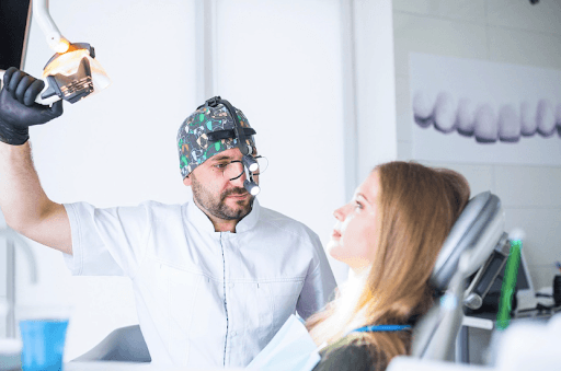A dentist conducting a suitability assessment for a patient before a dental implant procedure. 